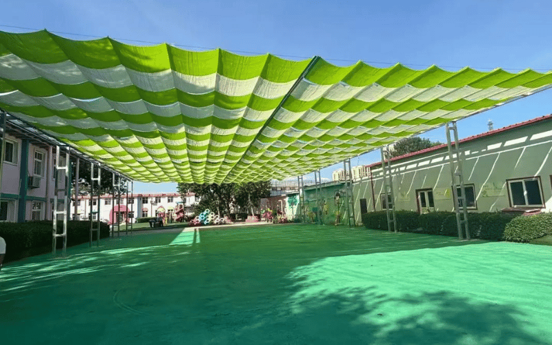 Incorporating Shade and Weather ProtectionComfort is key to keeping kids and caregivers happy during playtime. Incorporate shade and weather protection to ensure the space is usable year-round. Install canopies or shade sails over high-traffic areas like swings and slides to protect children from the sun. If you have natural shade, such as trees, position benches or quiet zones beneath them for a cool retreat. For areas without natural coverage, consider adding pergolas or umbrellas. In regions with frequent rain, a small covered play area can keep kids active even on wet days. Weather protection not only enhances comfort but also extends the usability of your play area.