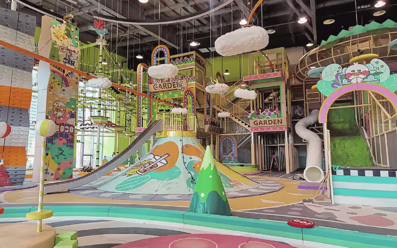 Colorful indoor kids soft play area with slides, climbing walls and multi level adventure structure Colorful indoor kids soft play area with slides, climbing walls and multi level adventure structure