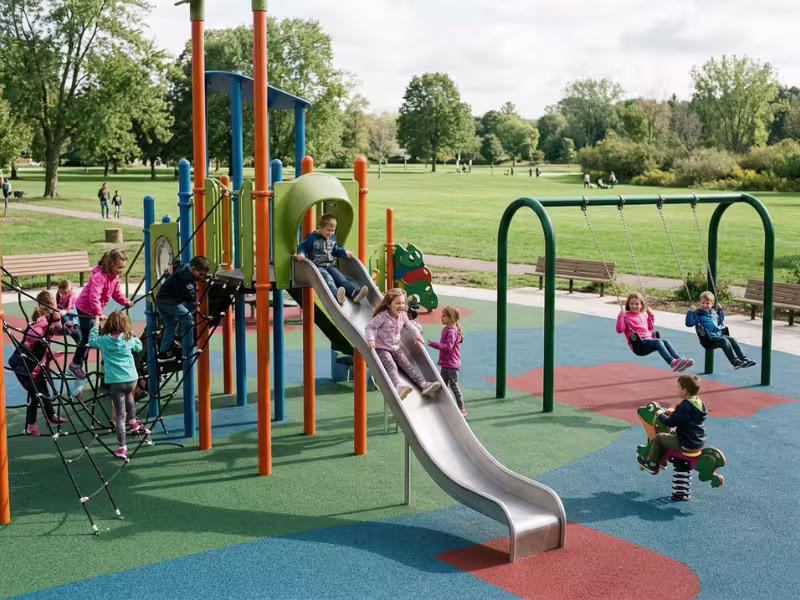 Children playing on varied outdoor playground equipment Children playing on varied outdoor playground equipment
