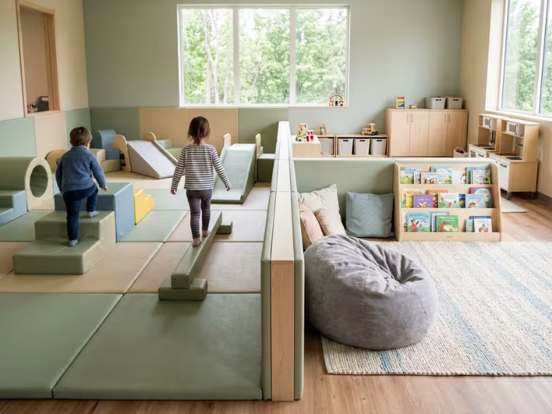 Daycare playroom with active play zone and reading corner Daycare playroom with active play zone and reading corner