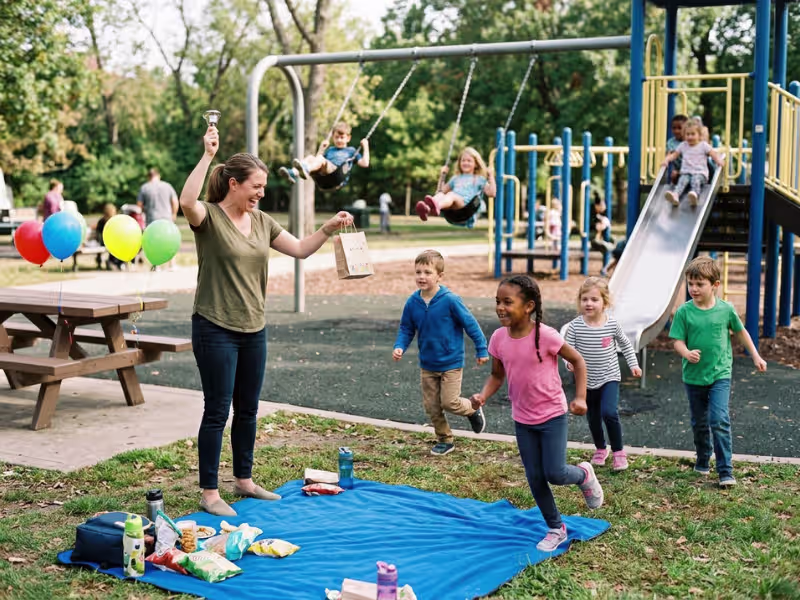 Parent gathering kids at a playground party Parent gathering kids at a playground party