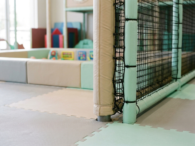 Safety netting, foam padding, and impact flooring close up Safety netting, foam padding, and impact flooring close up