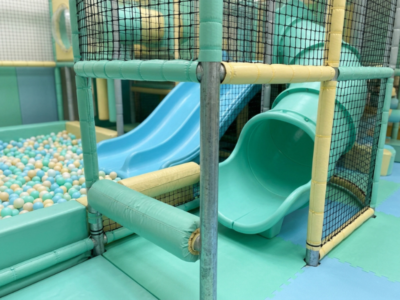 Soft play structure with slides, ball pit, and netting Soft play structure with slides, ball pit, and netting